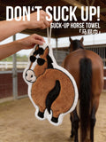 Hand holding OFF SCRIPT Flattery cartoon horse absorbent hand towel at a horse stable, with text Don't Suck Up Suck-Up Horse Towel