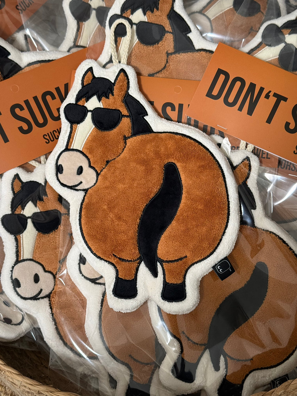 Multiple OFF SCRIPT Flattery horse-shaped absorbent hand towels in clear packaging with Don't Suck Up orange tags, product stock view